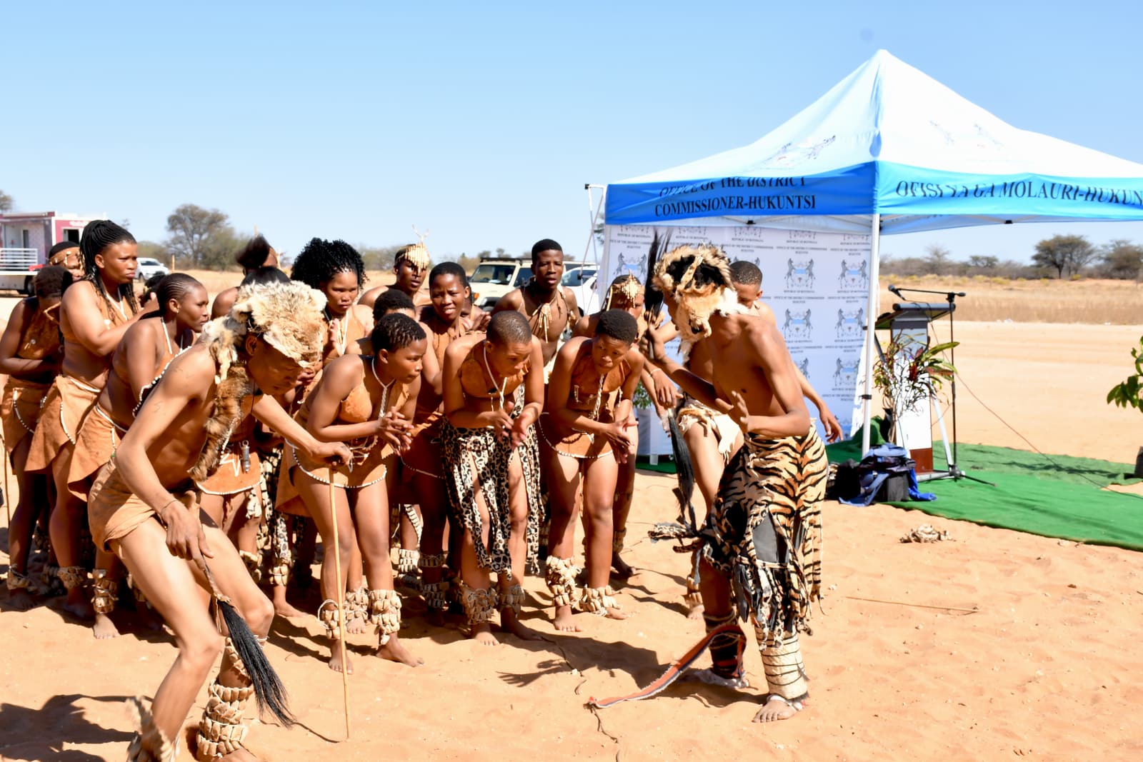 Traditional dancers in animal-skin dress performing in Botswana